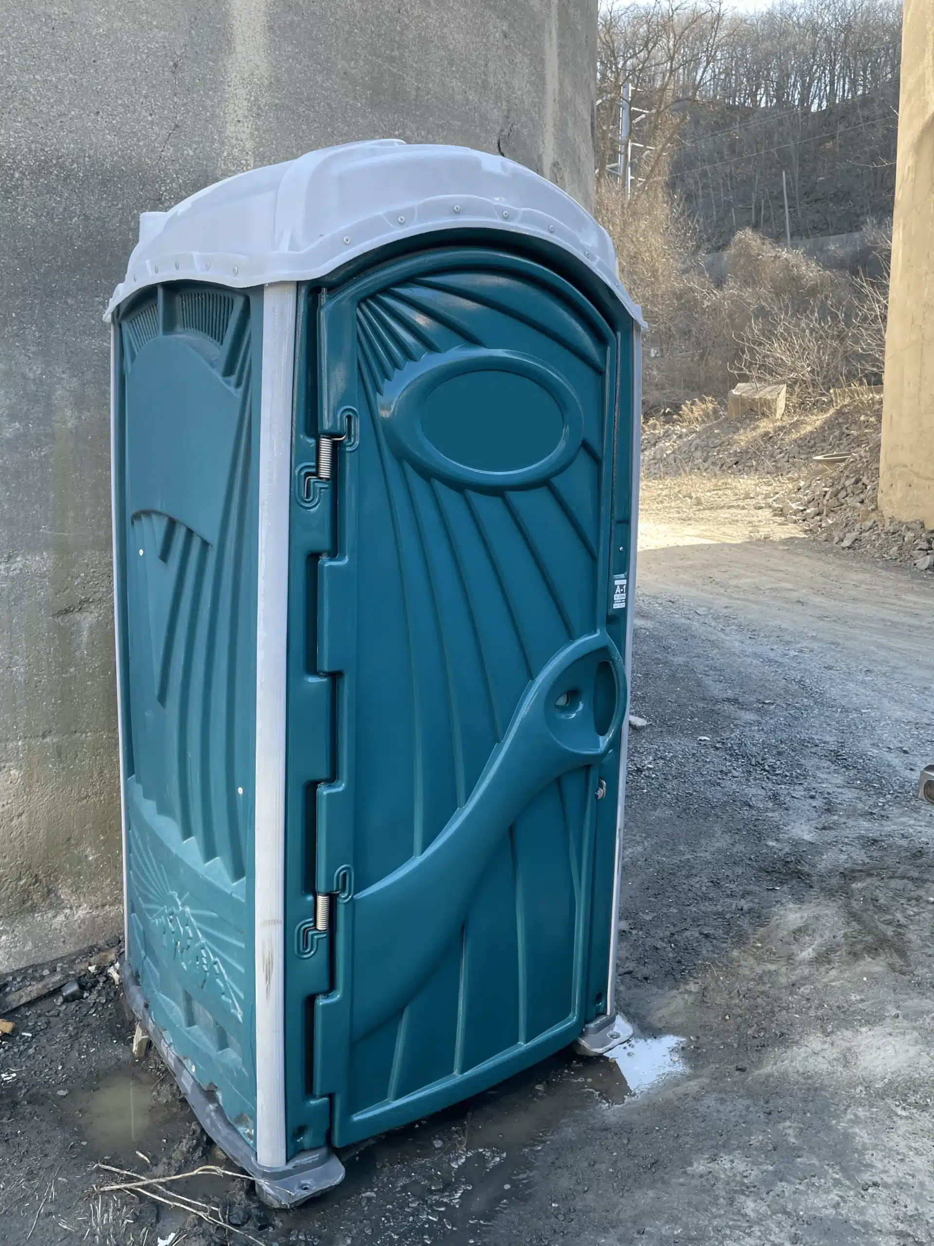 green portable toilet on a construction site ny